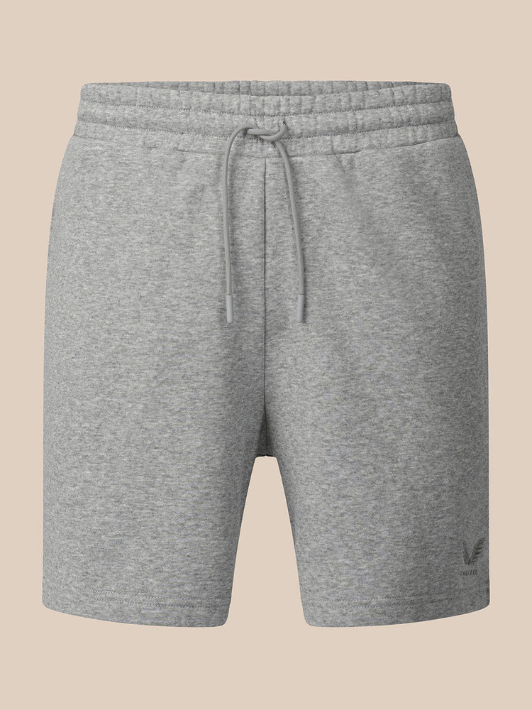 A pair of heather gray sweat shorts with an elastic drawstring waistband, shown against a solid beige background.