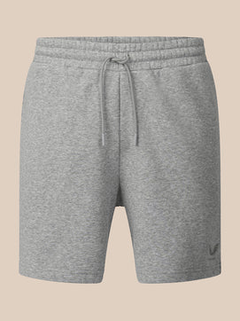 A pair of heather gray sweat shorts with an elastic drawstring waistband, shown against a solid beige background.