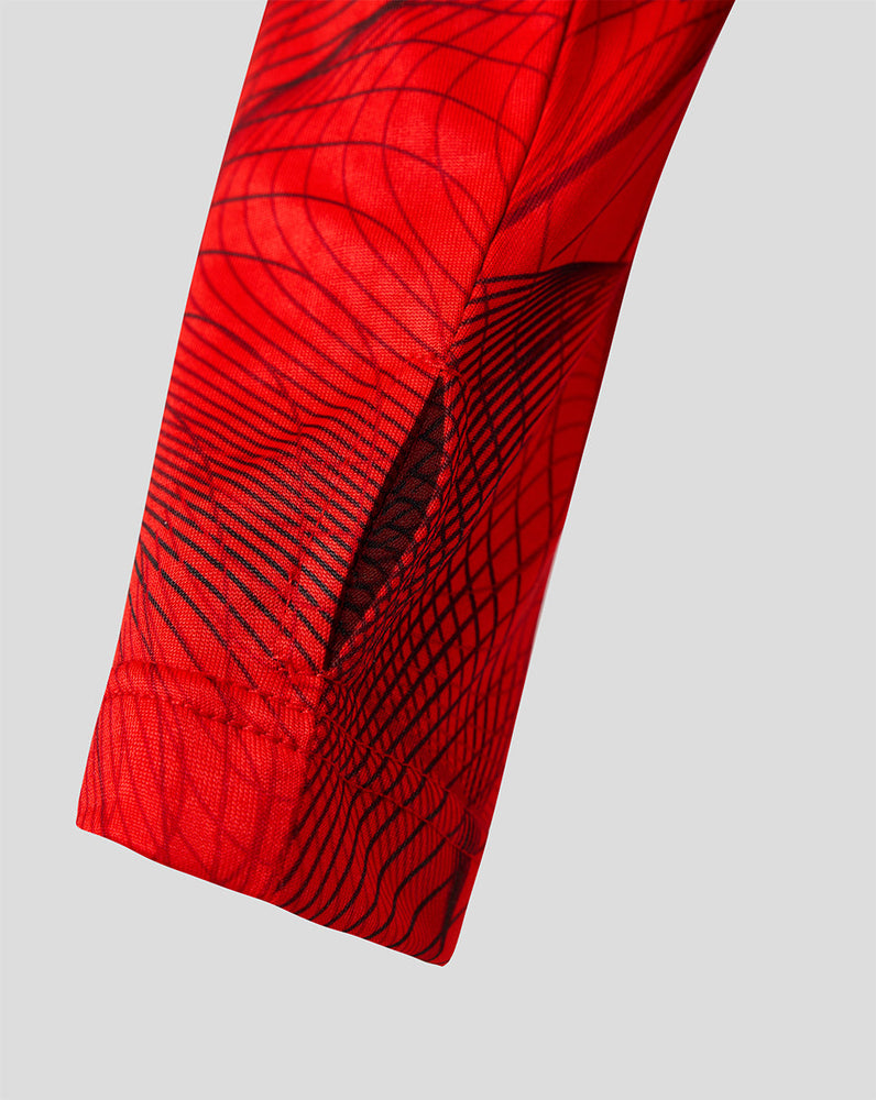 Close up of red patterned fabric on a Feyenoord junior matchday midlayer top.