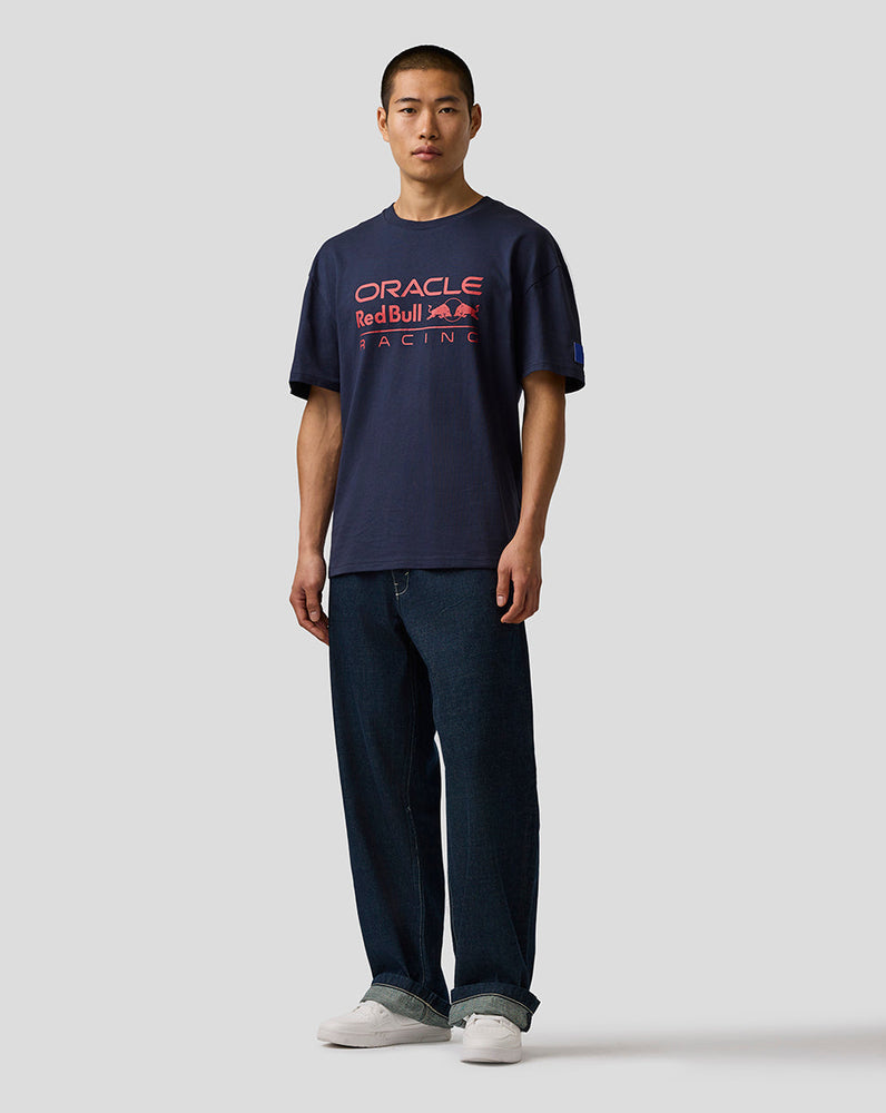 Person wearing a navy blue t-shirt with red and white text on a plain background
